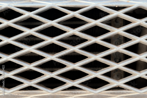 Close up of old metallic car grille, close up background.