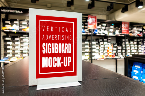 Mock up blank signboard on counter of shoes store photo