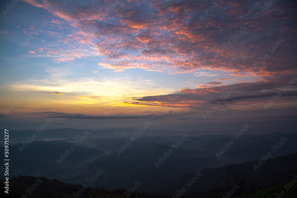 Naklejka premium colorful clouds on sunrise mountains