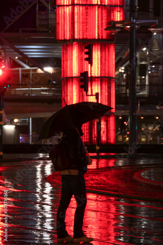 Stockholm, Sweden A woman with an umbrella in the rain at Sergels Torg. photo