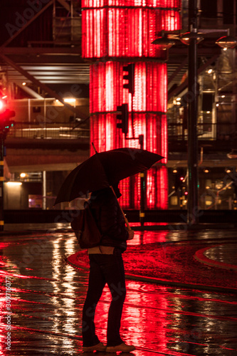 Stockholm, Sweden A woman with an umbrella in the rain at Sergels Torg. photo