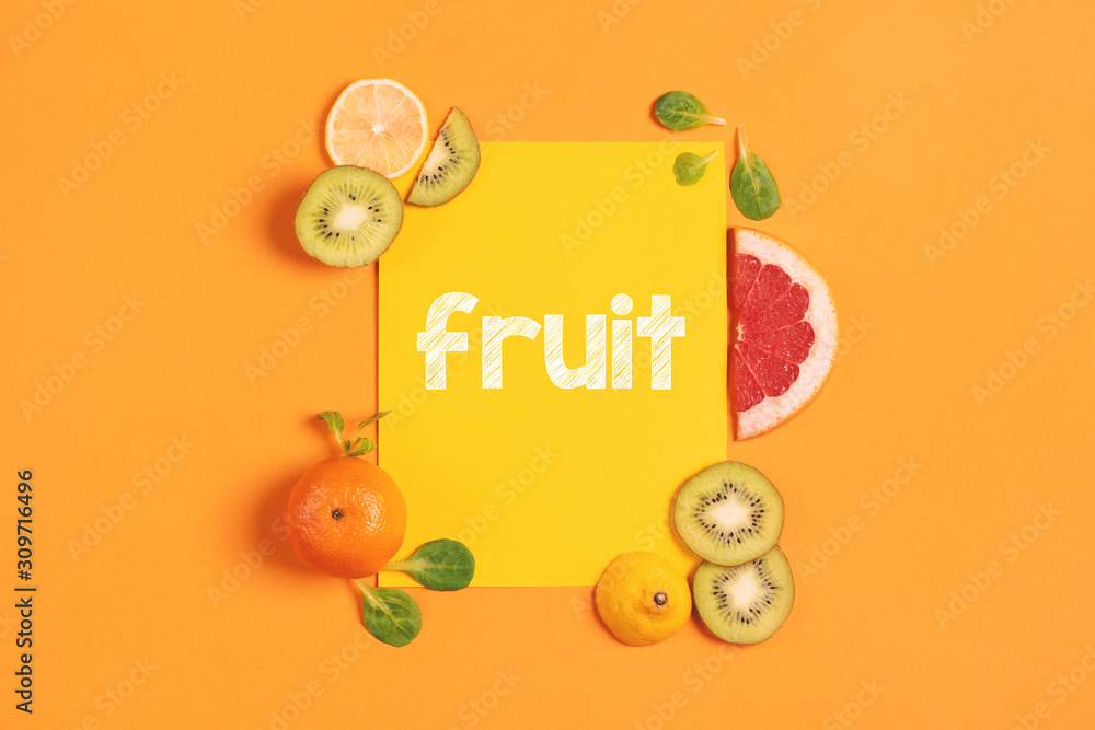 Fototapeta Composition of citrus fruit, orange, lemon and kiwi on yellow background