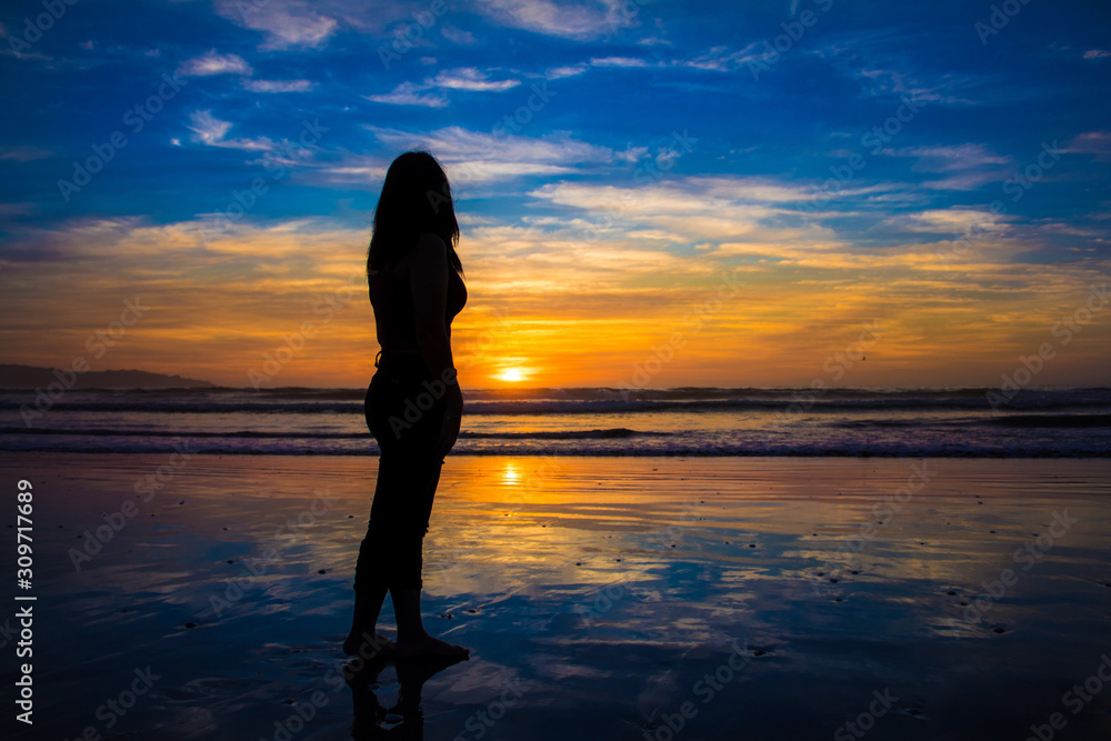 silhouette of young woman at sunset silhouette of young woman at sunset