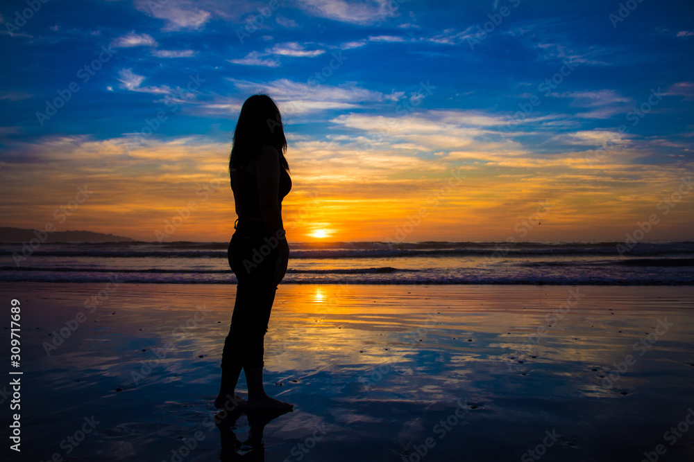 silhouette of young woman at sunset