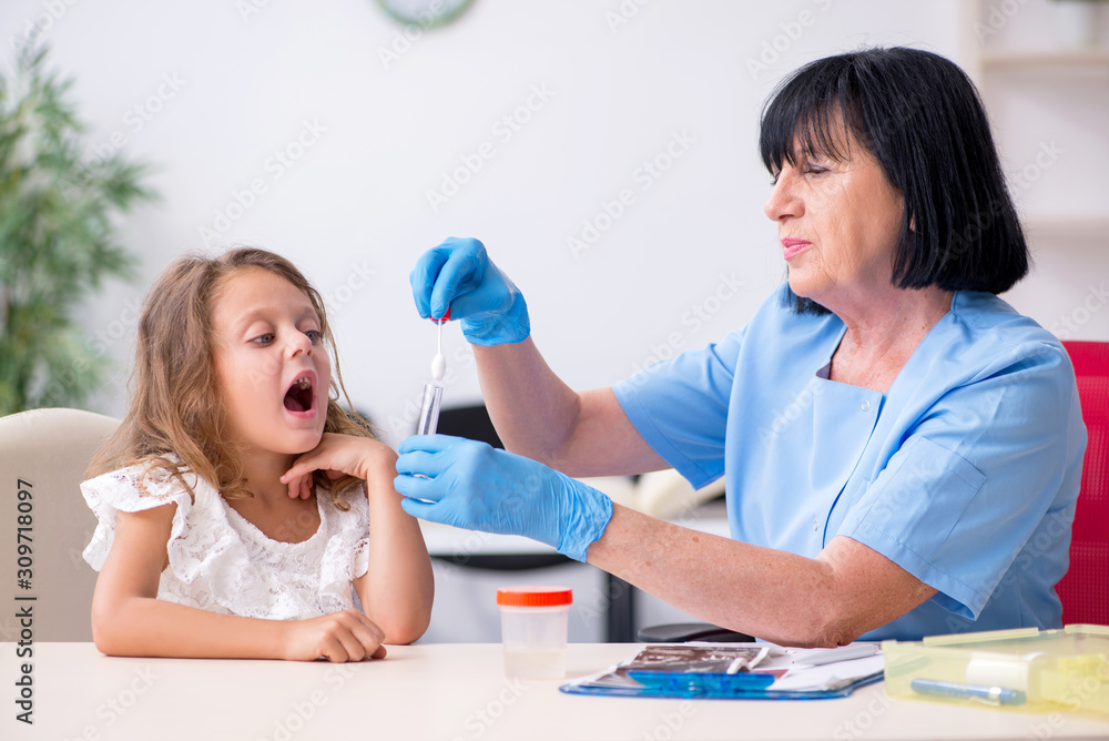 Little girl visiting old female doctor Little girl visiting old female doctor
