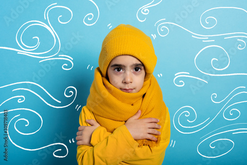 Child covers herself to avoid catching a cold. Cyan background