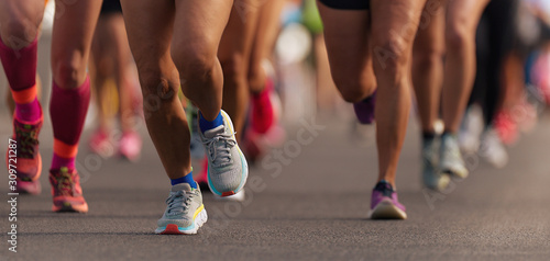 Fototapeta Naklejka Na Ścianę i Meble -  Marathon running race, people feet on city road