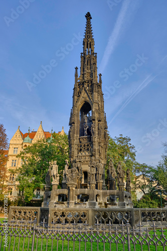 Scenic view of Kranner's Fountain (Krannerova kasna) in park of bank Vlatva river in capital of Czech Republic Prague. Beautiful sunset summer look of medieval fountain in ancient touristic town
