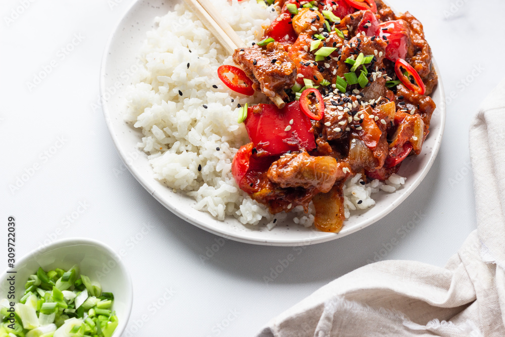Rice with stir fried pork, vegetables and green onion. Asian cuisine. Comfort food. Rice with stir fried pork, vegetables and green onion. Asian cuisine. Comfort food.