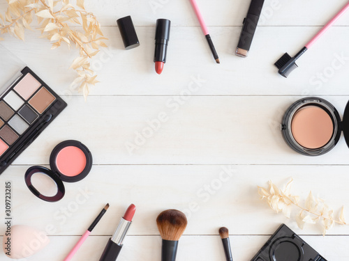 top view of cosmetics concept with lipstick, makeup products, Eyeshadow Palette, powder on white color table background.