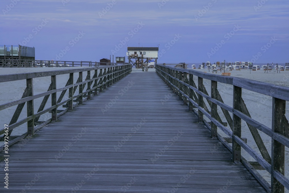 Fototapeta premium footbridge and stilt house in Sankt Peter-Ording