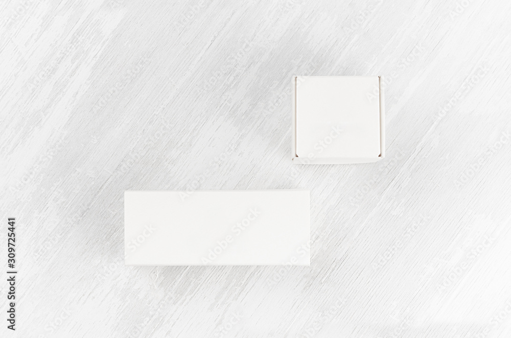 White blank closed paper two boxes - square, rectangle mock up on white wood board top view for design, branding identity, advertising, presentation. White blank closed paper two boxes - square, rectangle mock up on white wood board top view for design, branding identity, advertising, presentation.