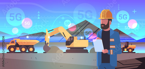 open pit man worker using tablet 5G online wireless system connection excavator loading soil on dump truck coal mine production opencast stone quarry background portrait horizontal vector illustration