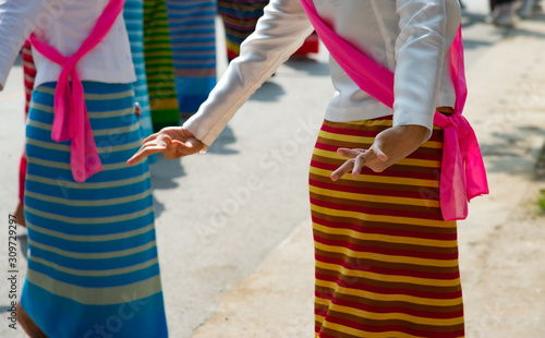 Close up dancers in beautiful colorful Northern Thai costumes show Thai dance during Yi Peng festival ceremony.