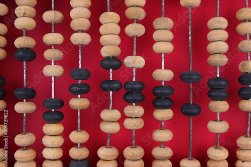 vintage wooden abacus on a red background.