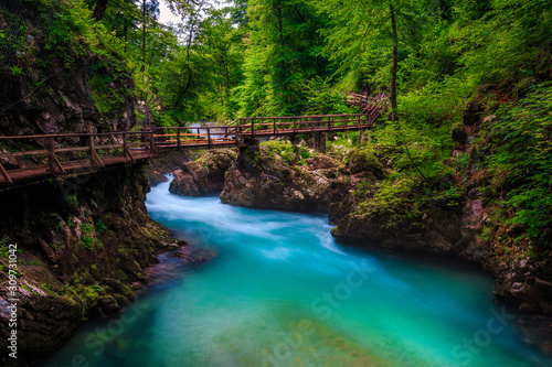 Turquoise Radovna river in Vintgar gorge and wooden footbridge, Slovenia