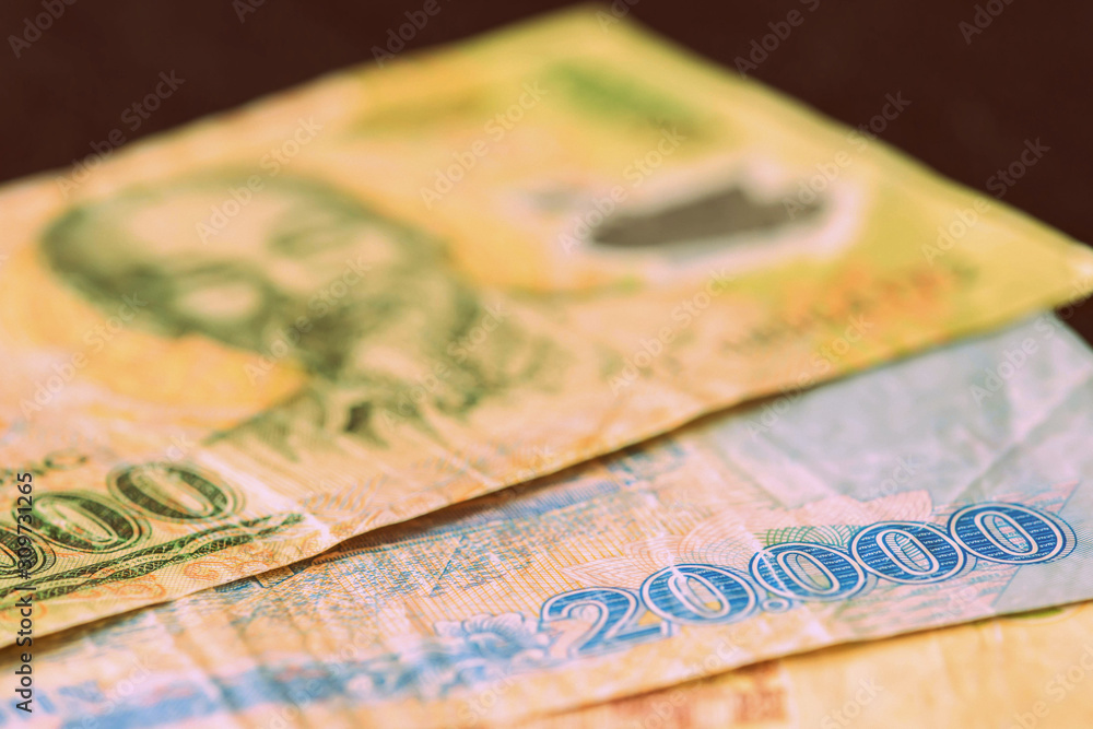 Vietnamese dong closeup on a dark background. Money background retro style toned Vietnamese dong closeup on a dark background. Money background retro style toned