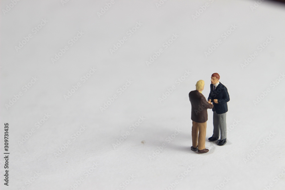 Gray Backgrond, Simple Illustration Photo for Mini Figure Two Man Toy Handshaking for Business Agreement Gray Backgrond, Simple Illustration Photo for Mini Figure Two Man Toy Handshaking for Business Agreement