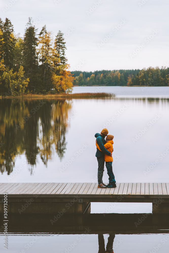 Couple in love hugging romantic dating family lifestyle relationship feelings concept man and woman standing on pier outdoor  lake and autumn forest landscape