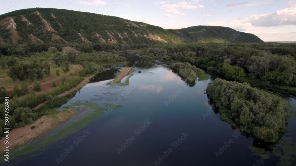 The remain of the reef of the ancient sea, composed of limestone - shikhan Kushtau on a summer day. The main river of Bashkiria - Belaya. Aerial view. The remain of the reef of the ancient sea, composed of limestone - shikhan Kushtau on a summer day. The main river of Bashkiria - Belaya. Aerial view.