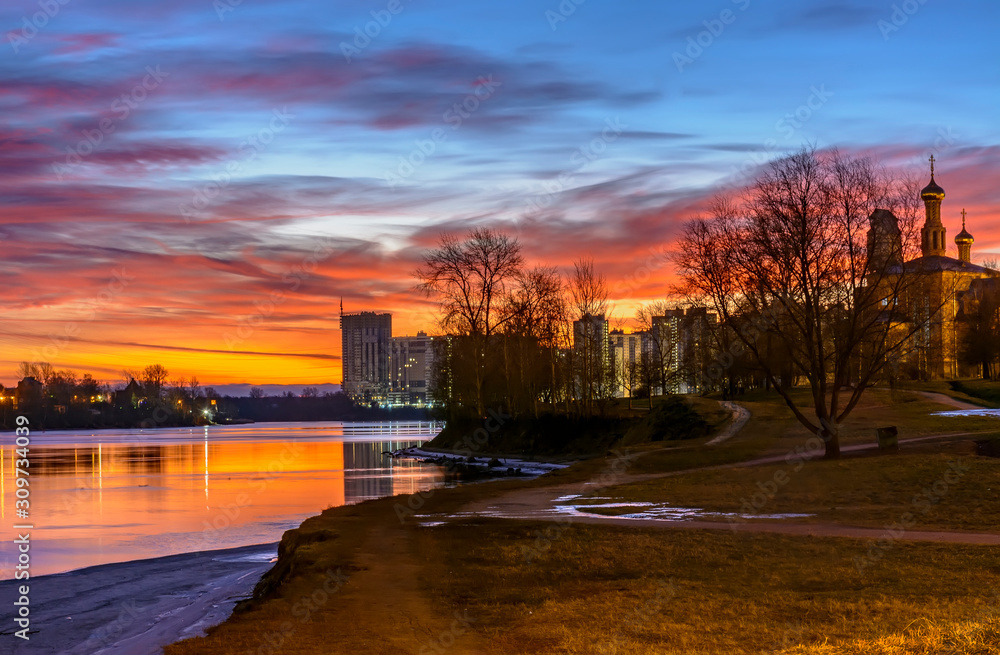 Bright December dawn on the Neva river in Rybatskoye district in