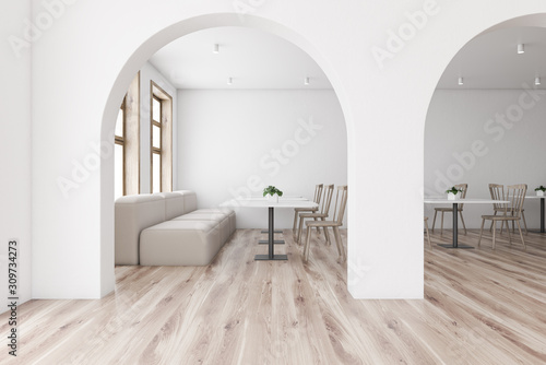 White restaurant interior with arches and sofa