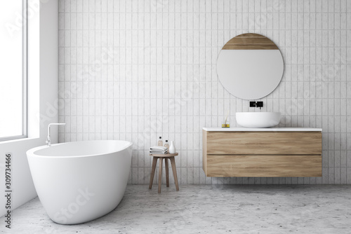 Luxury white tile bathroom  tub and round mirror