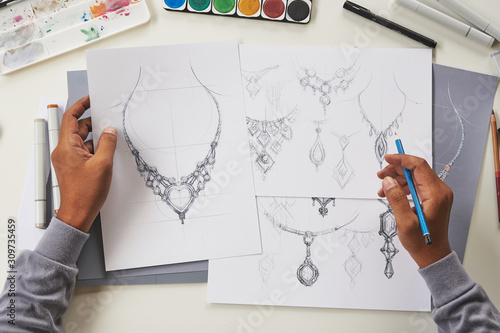 Designer design diamond jewelry drawing sketches making works craft unique handmade luxury necklaces product ideas.