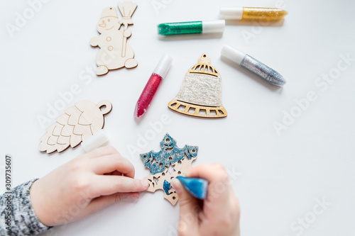 Workshop, girl mades a wooden christmas ornaments. Material for creativity. Step-by-step master class. wooden Toy for decorating the Christmas tree.Creative diy hobby. handmade craft, stylish