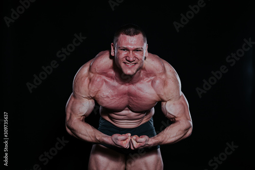 the athlete bodybuilder shows his muscles after sports