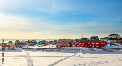 Arctic city center panorama with colorful Inuit houses at the fjord covered in snow, Ilulissat, Avannaata municipality, Greenland photo