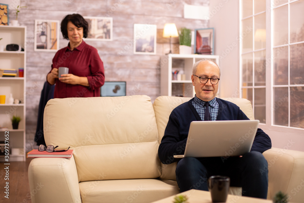 Elderly old couple using modern laptop to chat with their grandson Elderly old couple using modern laptop to chat with their grandson