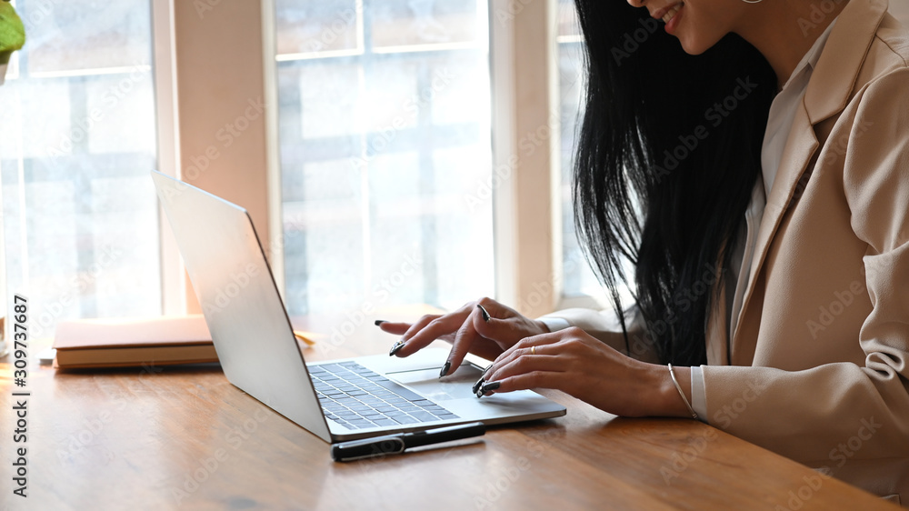 Cropped shot businesswoman using her laptop computer. Cropped shot businesswoman using her laptop computer.