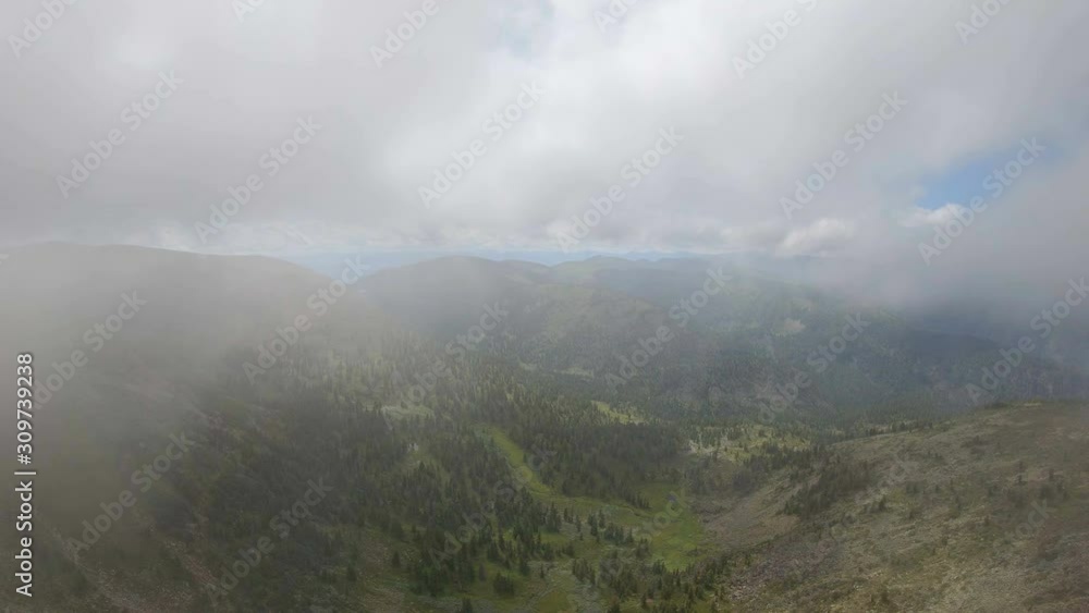 Aerial view of mountain landscape from cloud. Drone flying through the clouds in the mountains Aerial view of mountain landscape from cloud. Drone flying through the clouds in the mountains
