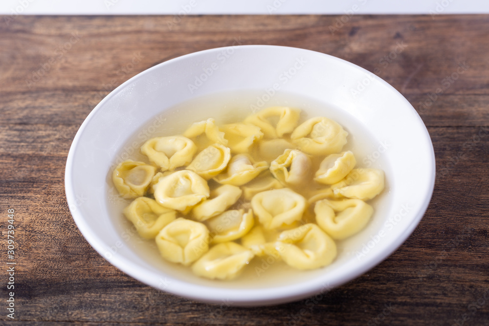 Tortellini in broth. Italian traditional dish. Winter food