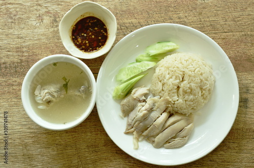 steamed rice topping boiled chicken with sauce and soup