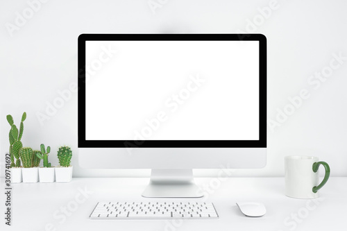 Computer with blank white copy space for text, Mockup design desktop computer in office on white table with keyboard and Coffee cub, Work place concept, Cactus in pot.
