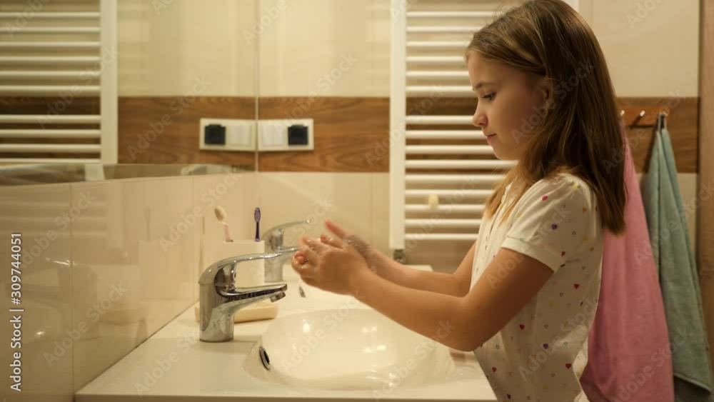 Cute kid girl hygiene washing hands lather with soap in bathroom in pajamas just after sleep in the morning Cute kid girl hygiene washing hands lather with soap in bathroom in pajamas just after sleep in the morning
