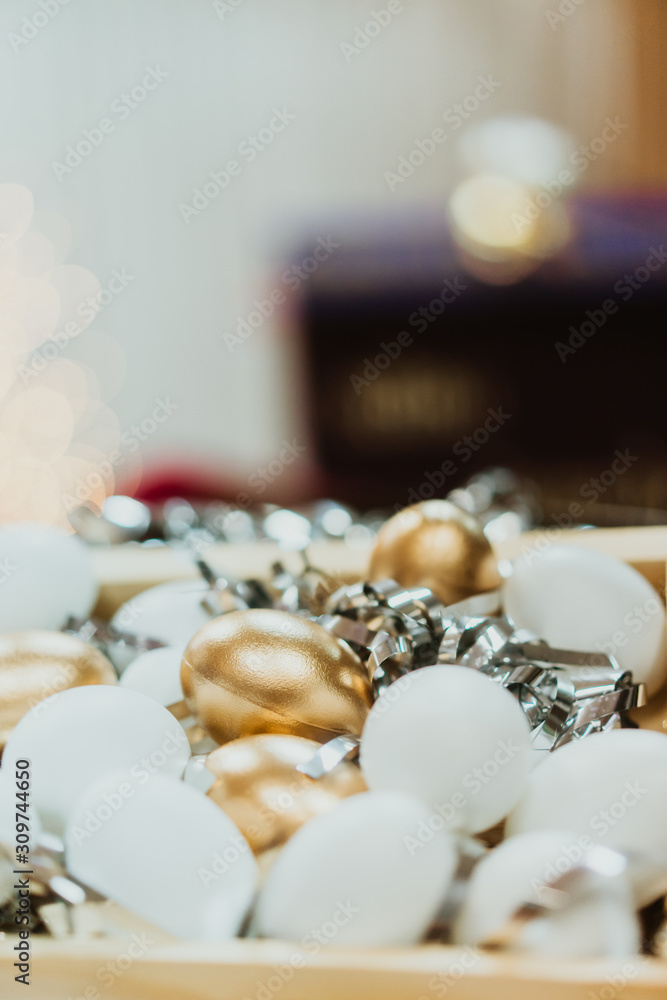 Top view of golden easter eggs colored with golden paint and white in wooden basket.Vintage film tone.Happy easter day. Top view of golden easter eggs colored with golden paint and white in wooden basket.Vintage film tone.Happy easter day.