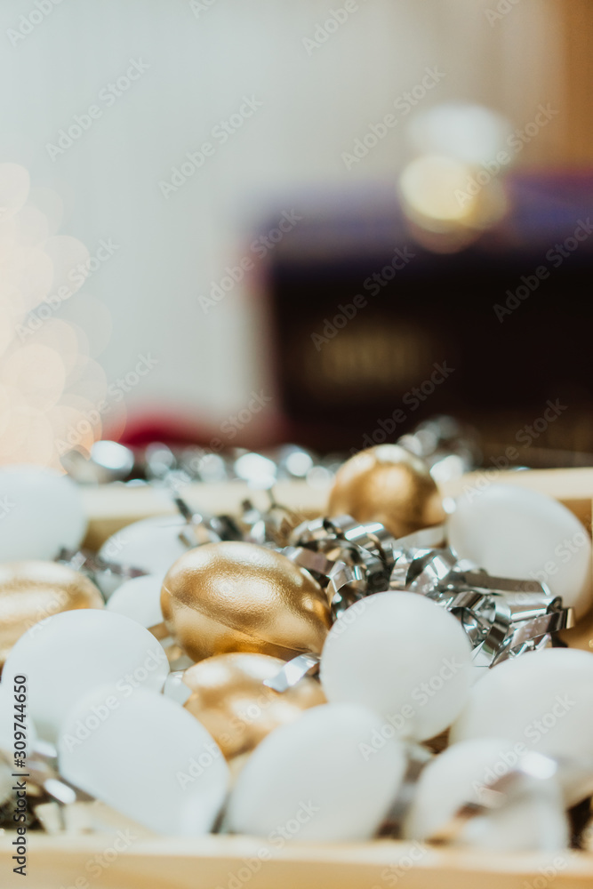 Top view of golden easter eggs colored with golden paint and white in wooden basket.Vintage film tone.Happy easter day.