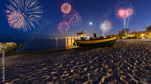 Happy New Year fireworks over Baltic Sea on the beach in Gdynia. Poland, Europe