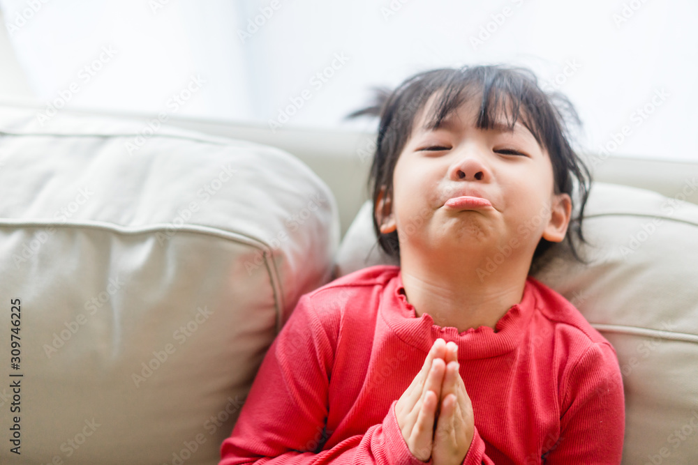 Real shot of regretful kid girl looks gloomy and desperate, keeps palms ...