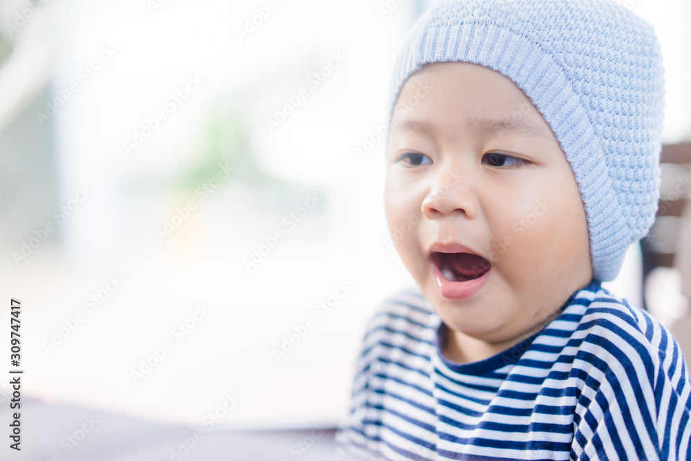 Little asian toddler boy wear hat and yawning in winter time.2 years old boy make sleepy face and tired face. Little asian toddler boy wear hat and yawning in winter time.2 years old boy make sleepy face and tired face.