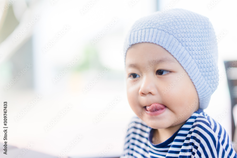 Baby boy make delicious face when he eat yummy food in restaurant.Enjoying delicious face. Baby boy make delicious face when he eat yummy food in restaurant.Enjoying delicious face.