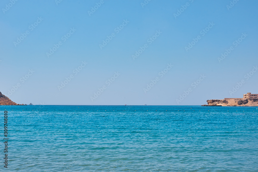 Beautiful view of sea cost against blue sky Beautiful view of sea cost against blue sky