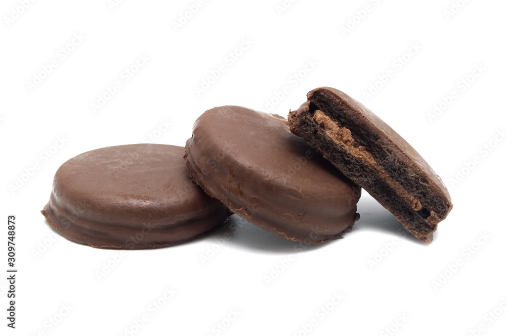 Chocolate sandwich cookies filled and coated with chocolate cream isolated on white background. Chocolate sandwich cookies filled and coated with chocolate cream isolated on white background.