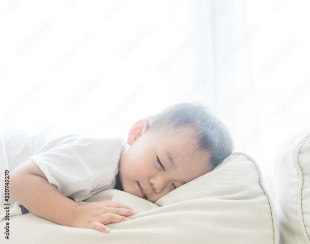 Toddler boy sleeping in sofa and dream.Asian 2 years old baby boy sleep on the sofa in living room.Sleep time,Comfortable, peaceful and growth hormone concept. Toddler boy sleeping in sofa and dream.Asian 2 years old baby boy sleep on the sofa in living room.Sleep time,Comfortable, peaceful and growth hormone concept.