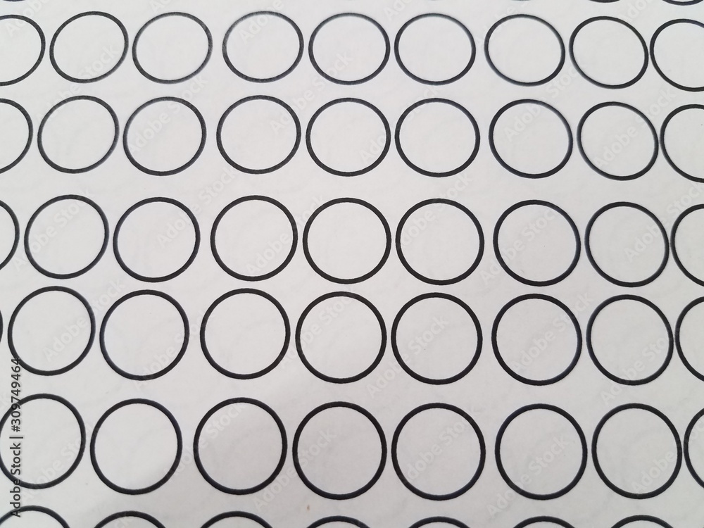 small black circles on white paper or background