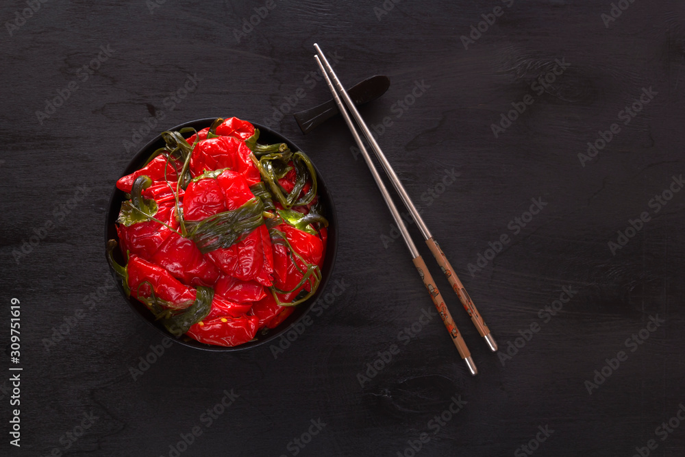 Fermented red hot peppers on a black table - traditional Korean food. Copy space. Top view Fermented red hot peppers on a black table - traditional Korean food. Copy space. Top view