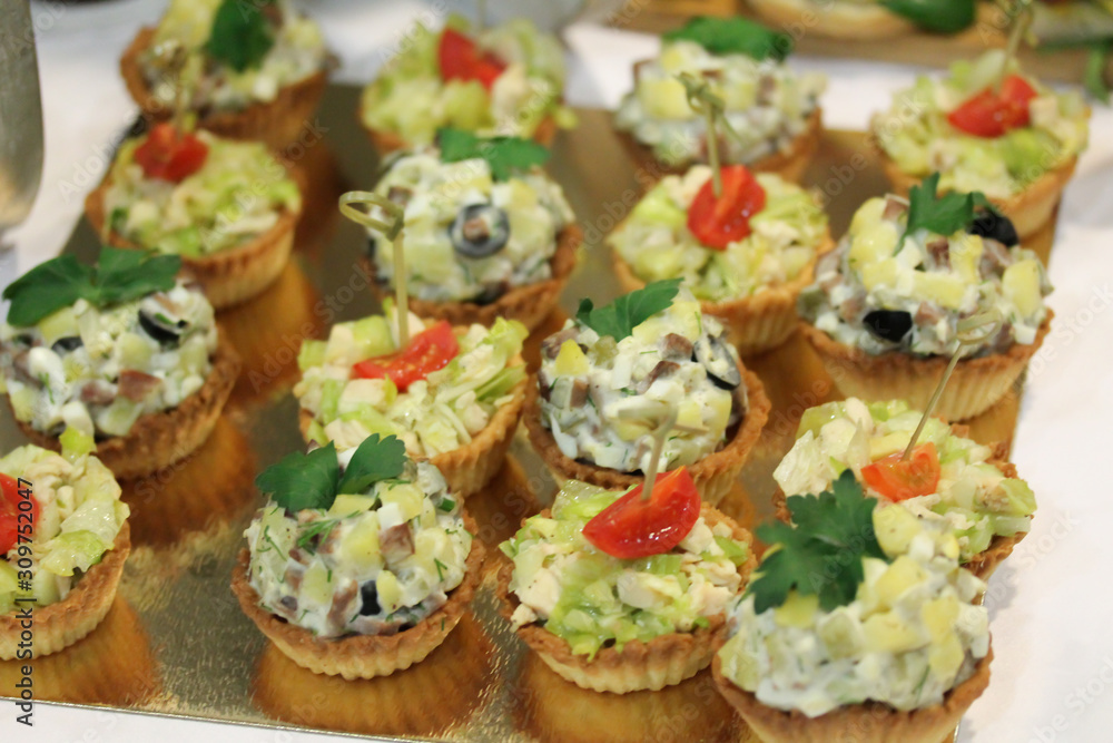 Salad muffins snacks at the stand-up party or buffet lunch. Tasty food treats on the table. Catering service.